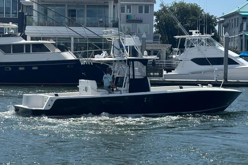  Yacht Photos Pics 2004 SeaVee 34 boat cruising in a marina, surrounded by other yachts.