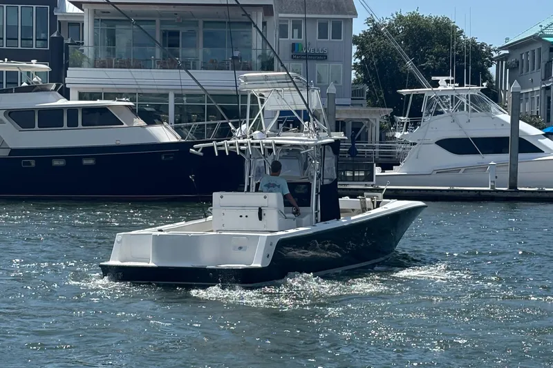  Yacht Photos Pics 2004 SeaVee 34 boat cruising in a marina with other yachts docked nearby.