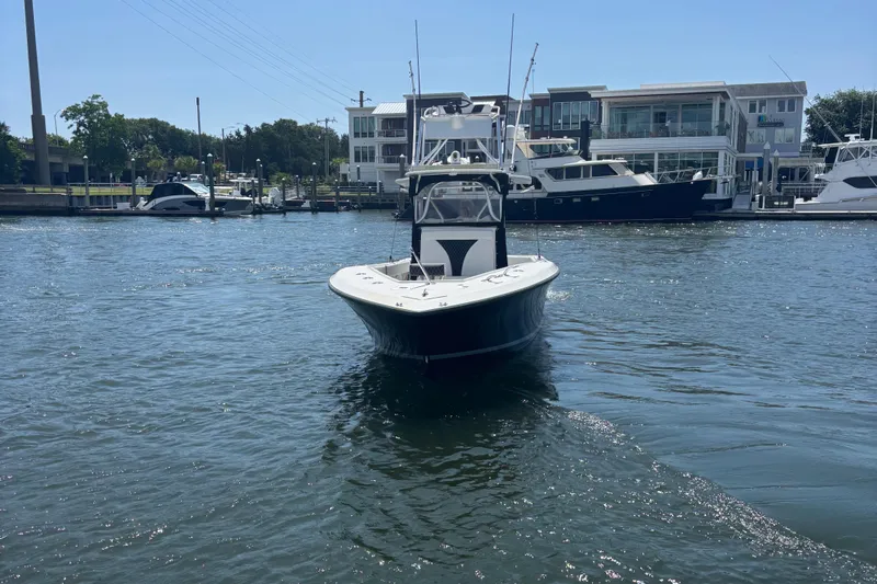  Yacht Photos Pics 2004 SeaVee 34 boat on water near marina with yachts in background.