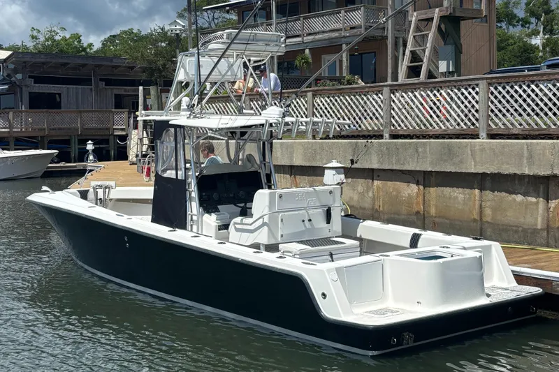  Yacht Photos Pics 2004 SeaVee 34 boat docked, featuring a sleek design and fishing equipment.