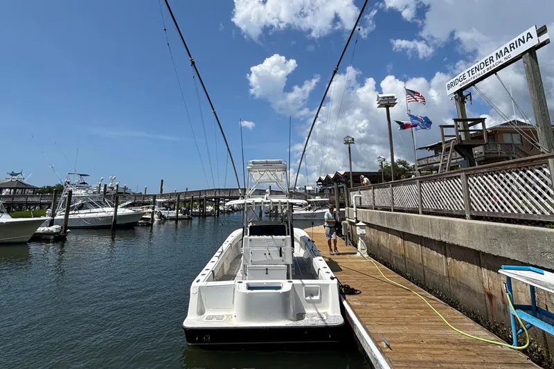  Yacht Photos Pics 2004 SeaVee 34 boat docked at Bridge Tender Marina under a clear blue sky.