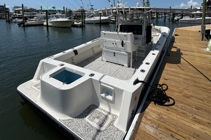  Yacht Photos Pics 2004 SeaVee 34 boat docked at marina, featuring spacious deck and fishing amenities.