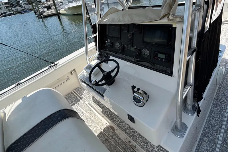  Yacht Photos Pics 2004 SeaVee 34 boat helm with steering wheel and controls, docked by the water.