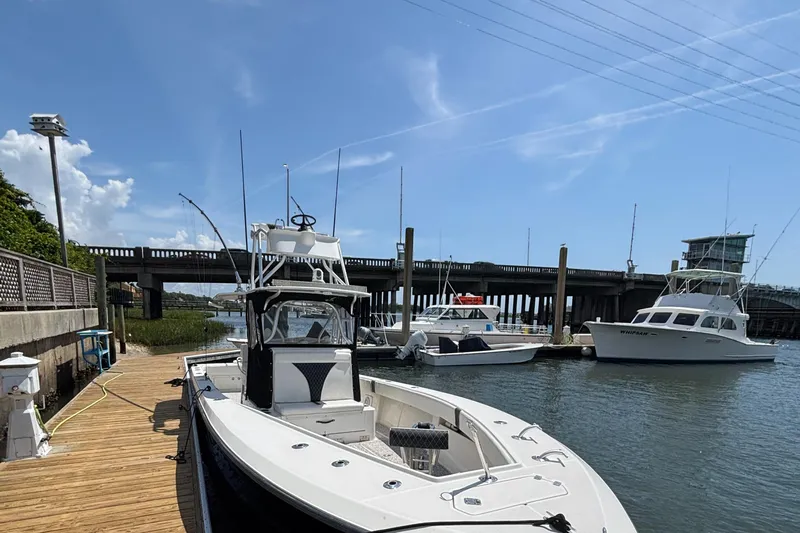  Yacht Photos Pics 2004 SeaVee 34 boat docked at marina with other vessels under clear blue sky.