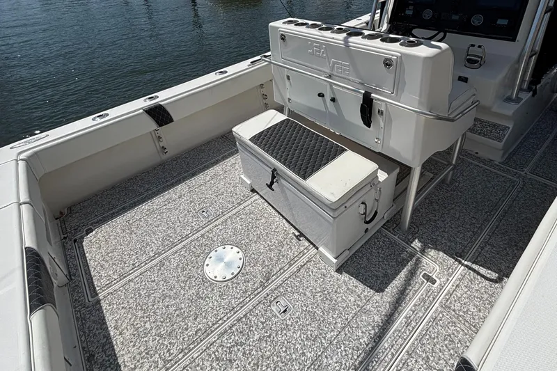 Yacht Photos Pics 2004 SeaVee 34 boat deck with storage and seating, featuring a clean, spacious layout.