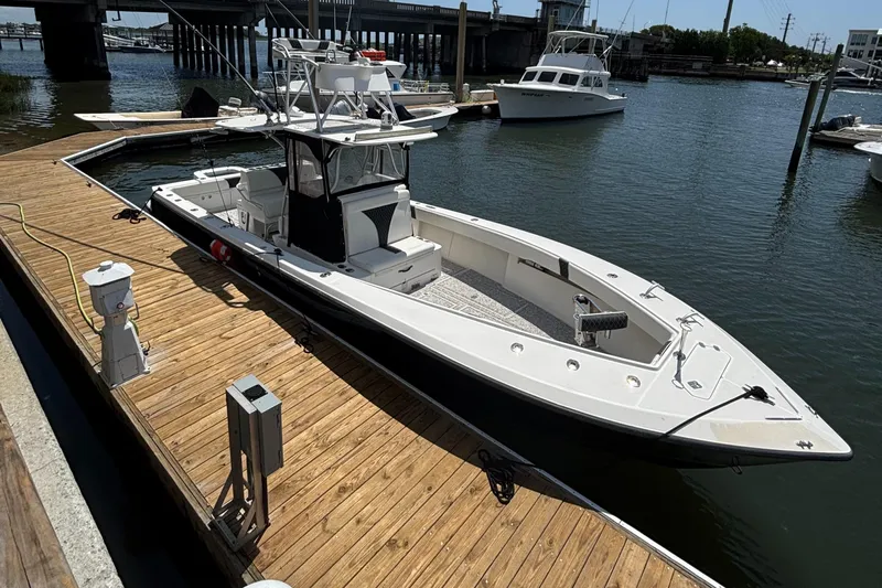  Yacht Photos Pics 2004 SeaVee 34 boat docked at marina, featuring sleek design and spacious deck.