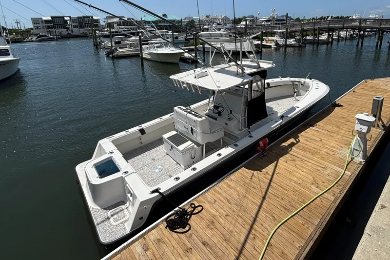  Yacht Photos Pics 2004 SeaVee 34 boat docked at marina, clear day, multiple boats in background.