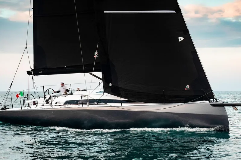 Bellissimo Yacht Photos Pics 2024 Neo 43 Romo sailboat with black sails on open water.