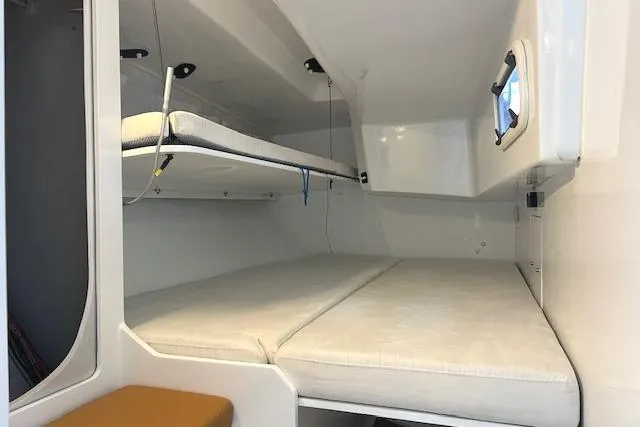 Bellissimo Yacht Photos Pics Interior cabin of 2024 Neo 43 Romo yacht with bunk beds and window.