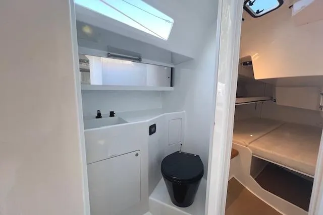 Bellissimo Yacht Photos Pics Interior of 2024 Neo 43 Romo yacht, featuring compact bathroom and cozy sleeping area.