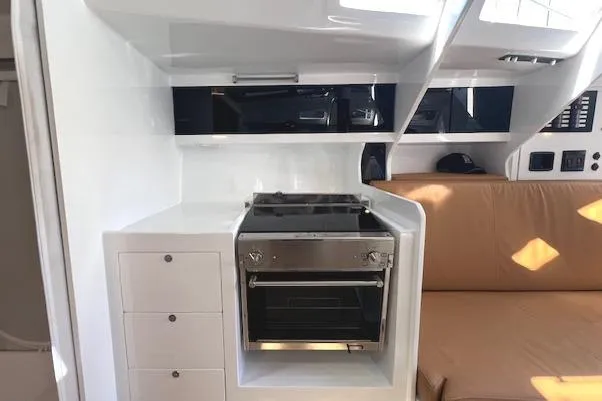 Bellissimo Yacht Photos Pics Modern kitchen area in 2024 Neo 43 Romo yacht with stove and seating.