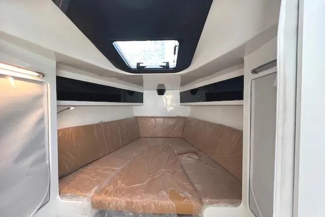Bellissimo Yacht Photos Pics Interior cabin of 2024 Neo 43 Romo boat with brown seating and overhead window.