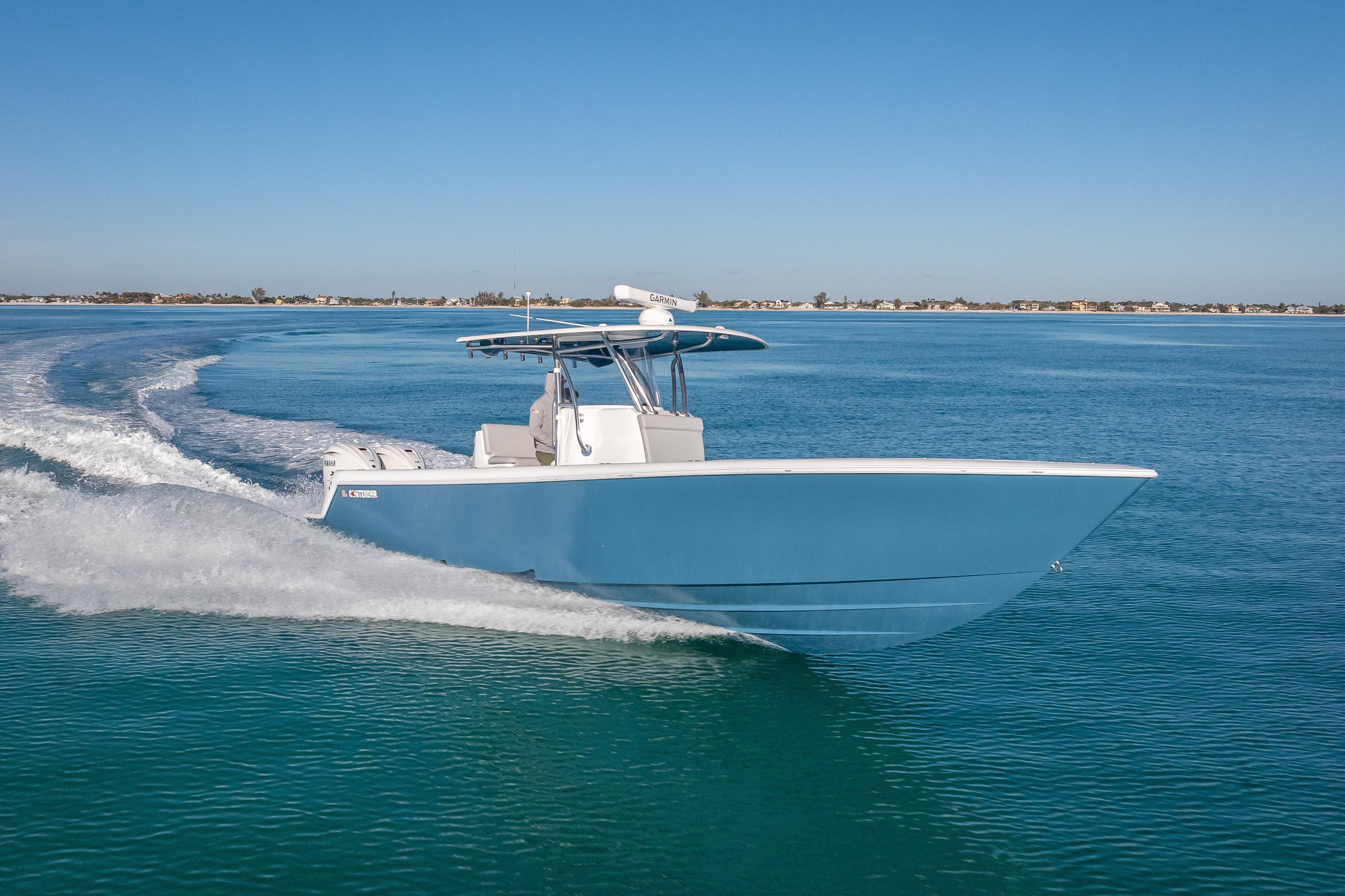 2026 Contender 35 ST boat cruising on clear blue water under a sunny sky.