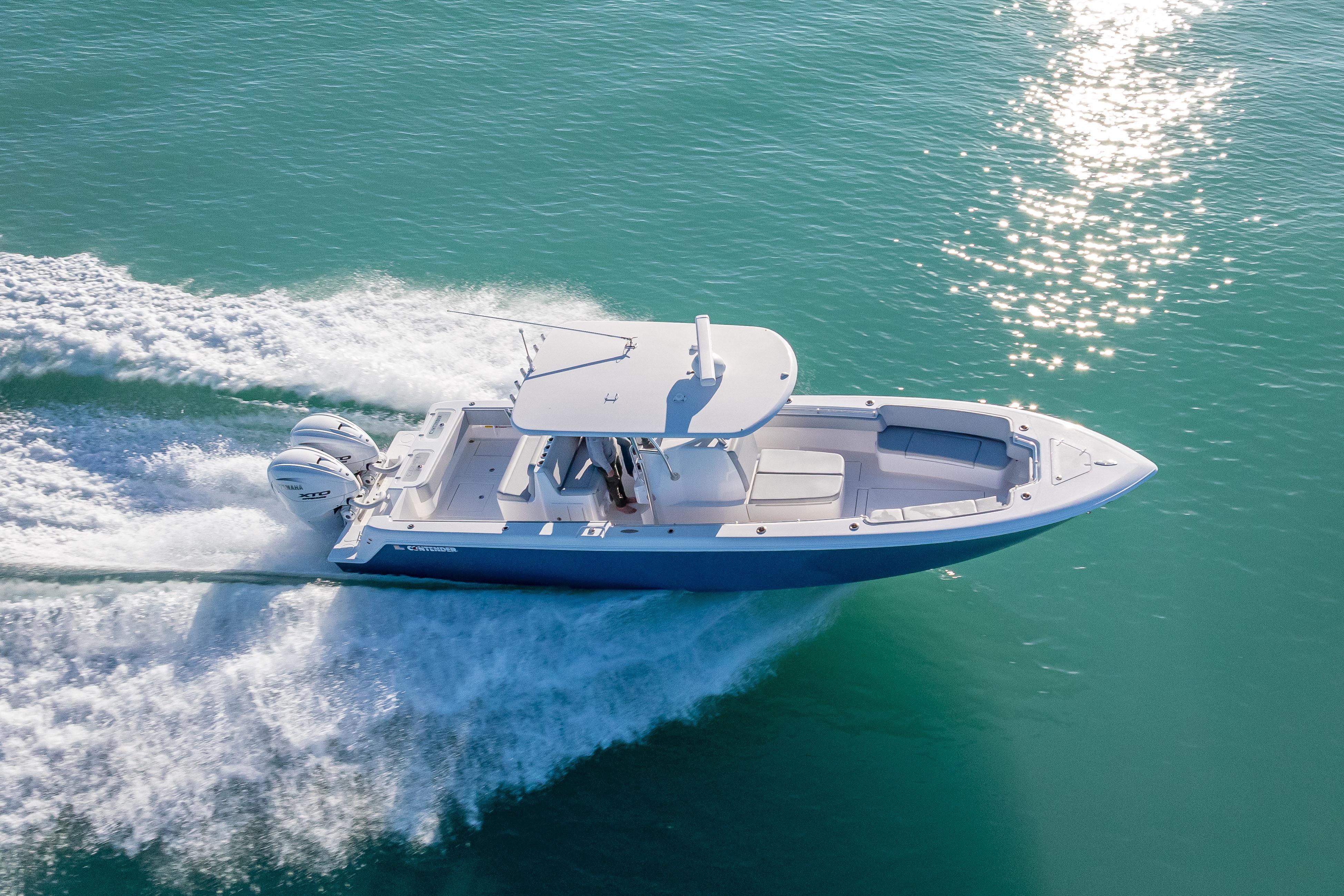 2026 Contender 35 ST boat cruising on clear turquoise water.