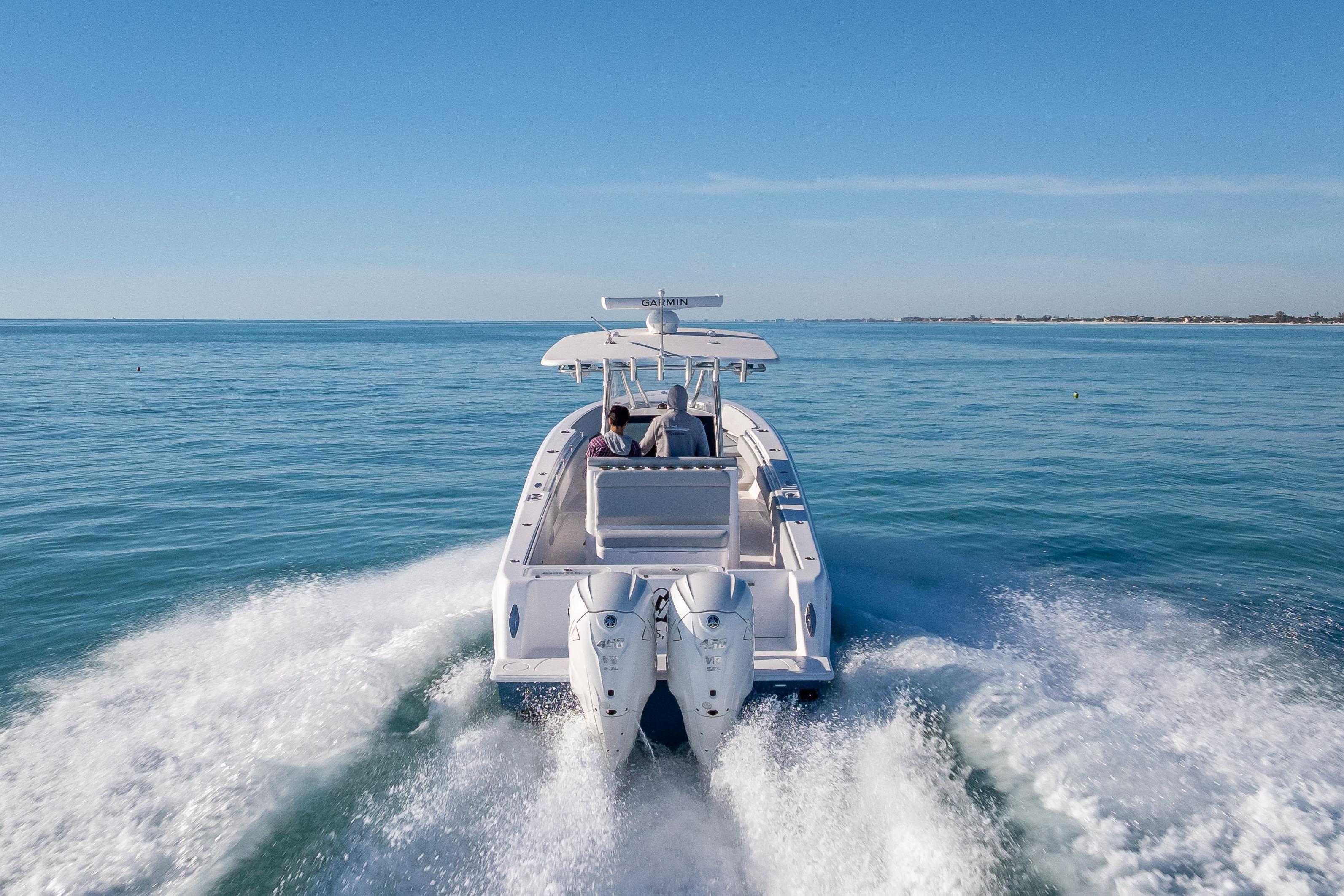 2026 Contender 35 ST boat cruising on open water, rear view.