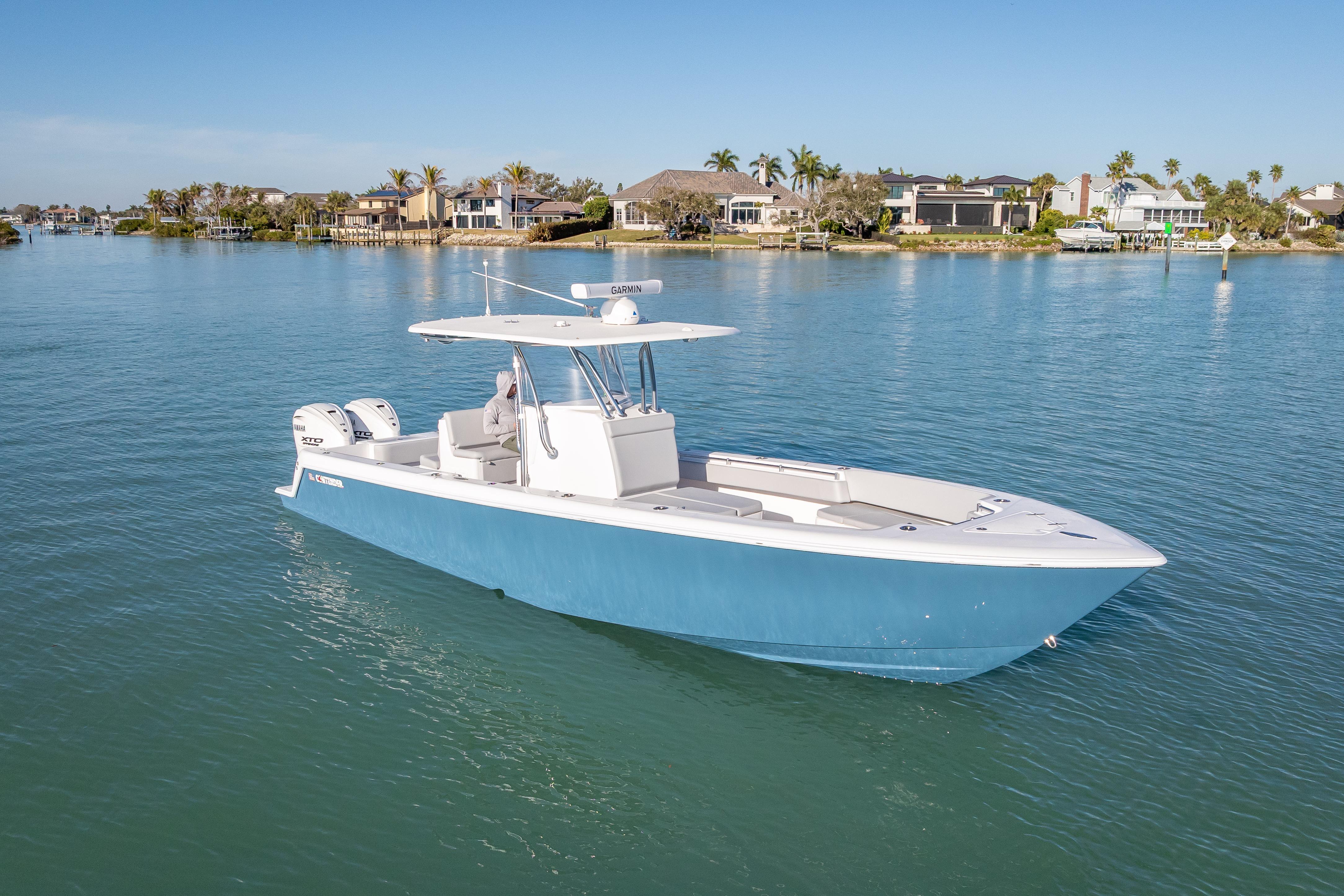 2026 Contender 35 ST boat on calm water, coastal homes in background.