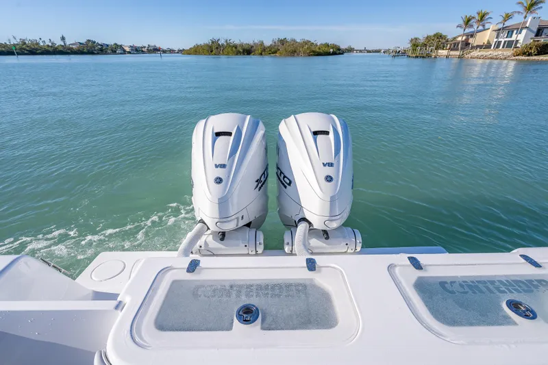  Yacht Photos Pics 2026 Contender 35 ST boat with twin V8 engines on a serene waterway.