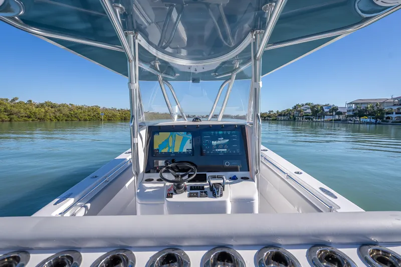  Yacht Photos Pics 2026 Contender 35 ST boat cockpit with advanced navigation system on calm waters.