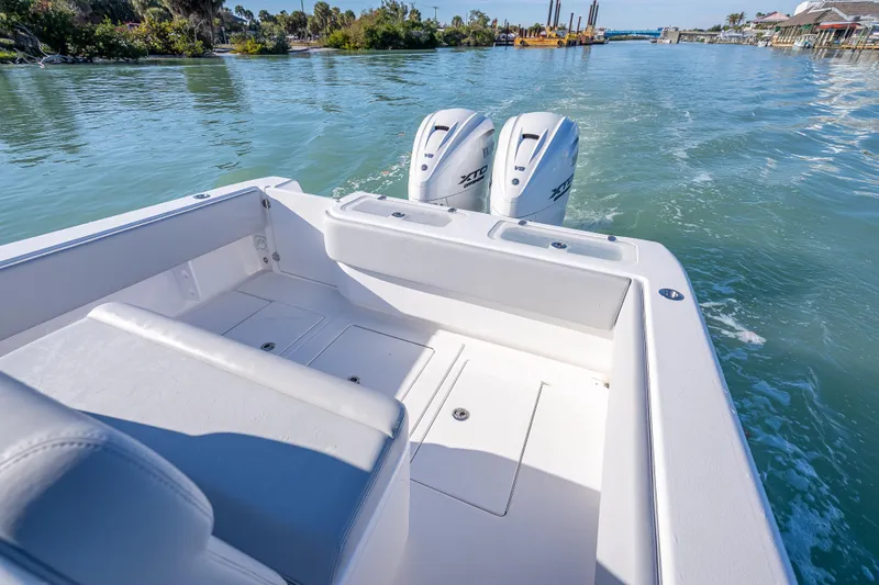  Yacht Photos Pics 2026 Contender 35 ST boat with dual outboard engines on a scenic waterway.