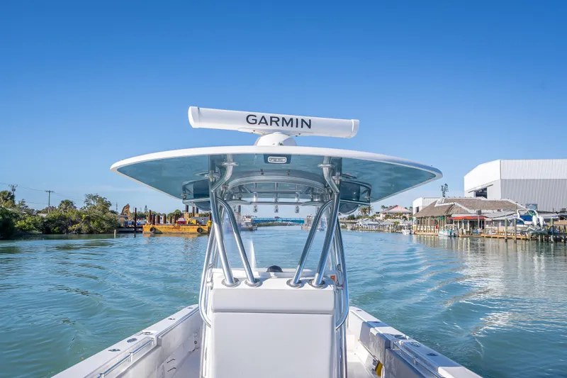  Yacht Photos Pics 2026 Contender 35 ST boat navigating a scenic waterway with clear blue skies.