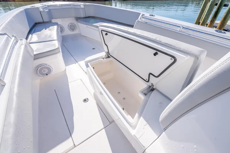  Yacht Photos Pics 2026 Contender 35 ST boat interior with open storage compartment and cushioned seating.