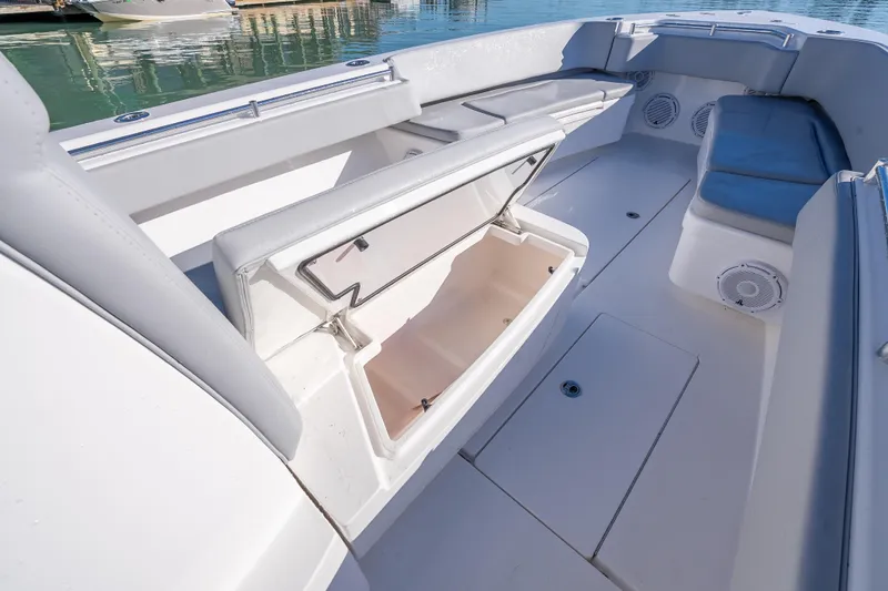  Yacht Photos Pics 2026 Contender 35 ST boat interior with open storage compartment and cushioned seating.