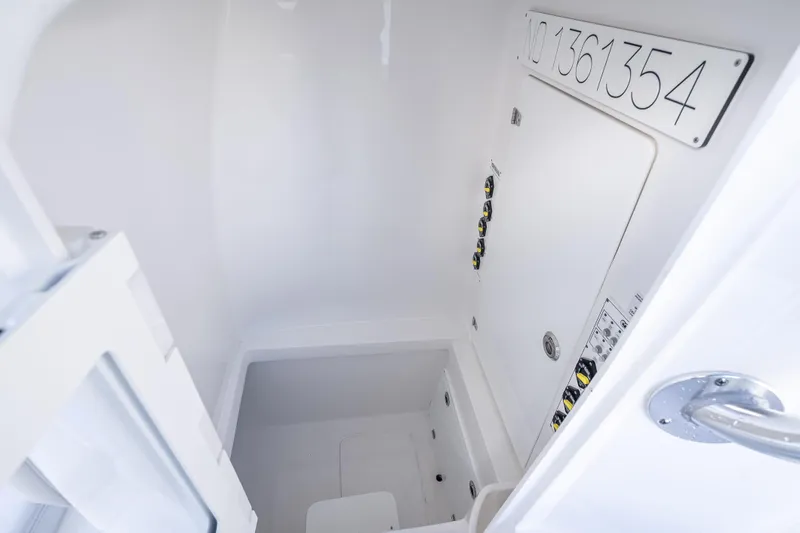  Yacht Photos Pics Interior of 2026 Contender 35 ST boat, featuring storage compartment and control panel.