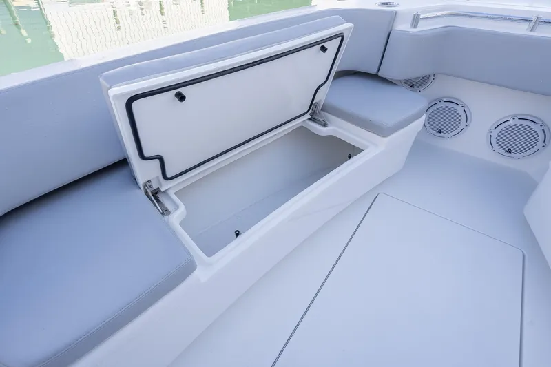  Yacht Photos Pics 2026 Contender 35 ST boat interior with open storage compartment and cushioned seating.