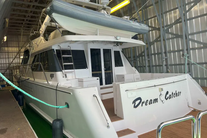 Dream Catcher Yacht Photos Pics 1998 West Bay 58 yacht "Dream Catcher" docked in a covered marina.