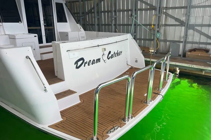 Dream Catcher Yacht Photos Pics 1998 West Bay 58 yacht "Dream Catcher" docked, featuring teak deck and stainless steel railings.