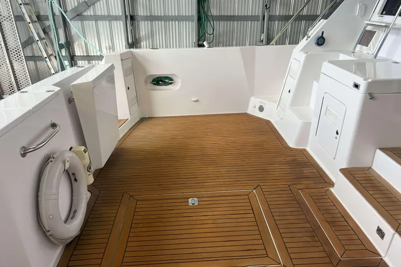 Dream Catcher Yacht Photos Pics 1998 West Bay 58 yacht deck with teak flooring and white storage compartments.