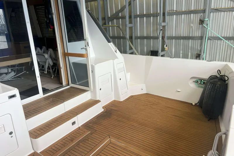 Dream Catcher Yacht Photos Pics 1998 West Bay 58 yacht deck with teak flooring and sliding glass doors.