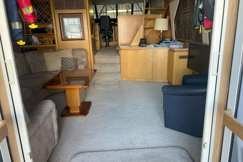 Dream Catcher Yacht Photos Pics Interior of a 1998 West Bay 58 yacht with cozy seating and wooden cabinetry.
