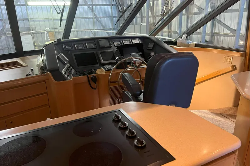 Dream Catcher Yacht Photos Pics Interior helm of 1998 West Bay 58 yacht with steering wheel and control panel.