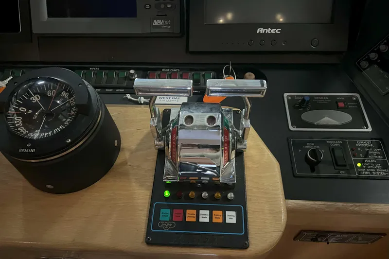 Dream Catcher Yacht Photos Pics Control panel of a 1998 West Bay 58 yacht with compass and throttle levers.