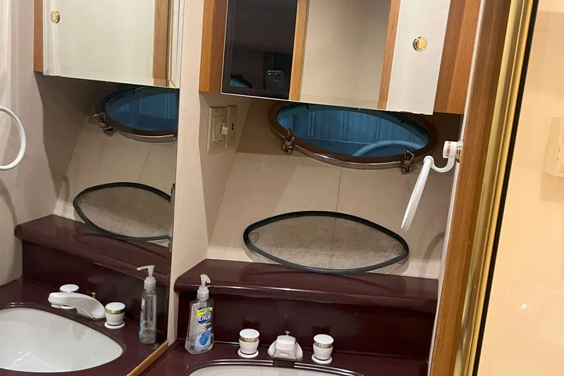 Dream Catcher Yacht Photos Pics Bathroom vanity in a 1998 West Bay 58 yacht with mirrors and toiletries.