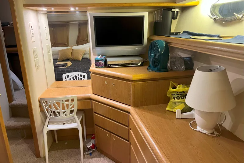 Dream Catcher Yacht Photos Pics Interior of 1998 West Bay 58 yacht with TV, desk, and lamp.