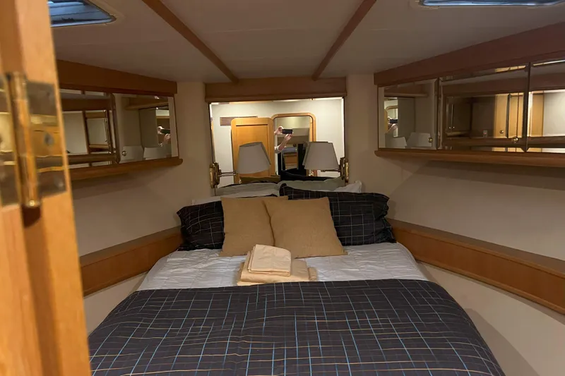 Dream Catcher Yacht Photos Pics Cozy bedroom in 1998 West Bay 58 yacht with plaid bedding and wooden accents.