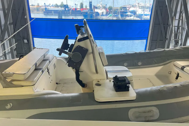 Dream Catcher Yacht Photos Pics 1998 West Bay 58 boat interior with steering console and seating in a marina setting.