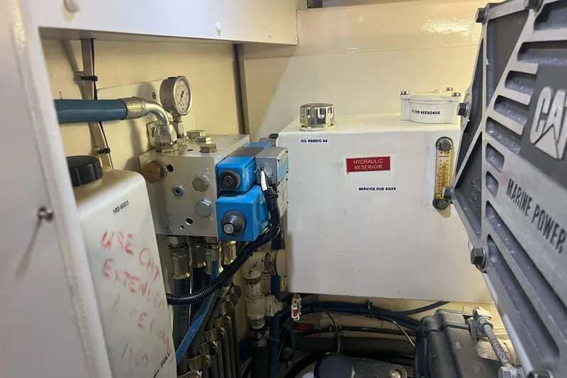 Dream Catcher Yacht Photos Pics Engine room of a 1998 West Bay 58 yacht, featuring hydraulic reservoir and marine power components.