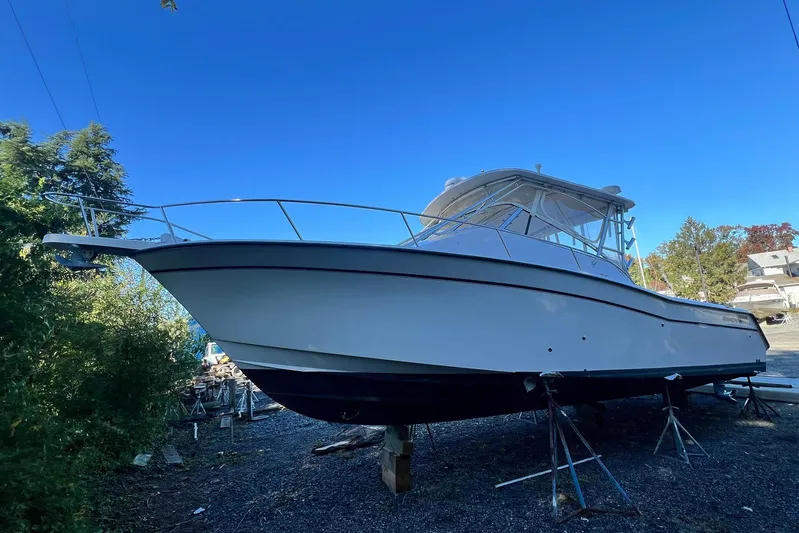 Zig Zag Yacht Photos Pics 2004 Grady-White Express 330 boat on stands, clear blue sky background.