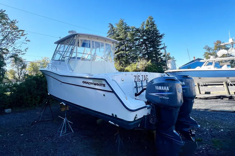 Zig Zag Yacht Photos Pics 2004 Grady-White Express 330 boat with twin Yamaha engines on a stand.