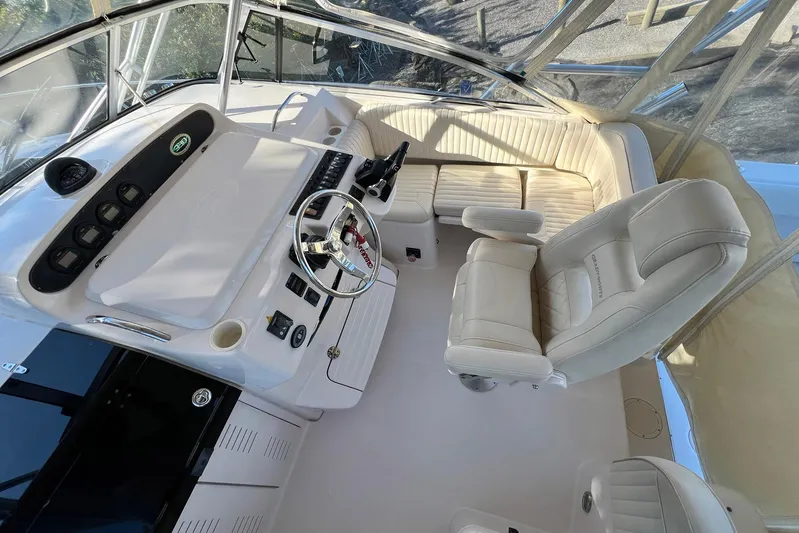 Zig Zag Yacht Photos Pics 2004 Grady-White Express 330 boat cockpit with steering wheel and seating.