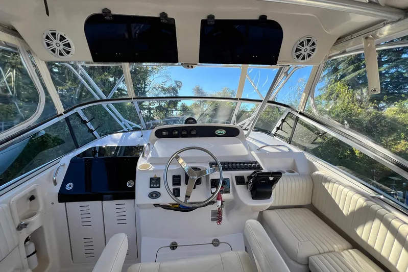 Zig Zag Yacht Photos Pics 2004 Grady-White Express 330 boat cockpit with steering wheel and seating.
