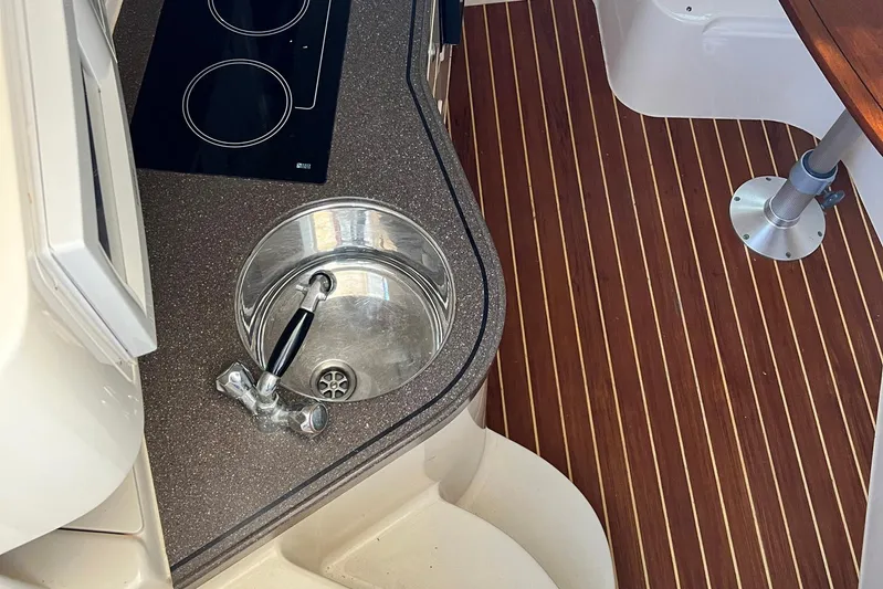 Zig Zag Yacht Photos Pics 2004 Grady-White Express 330 boat interior with sink and stovetop.