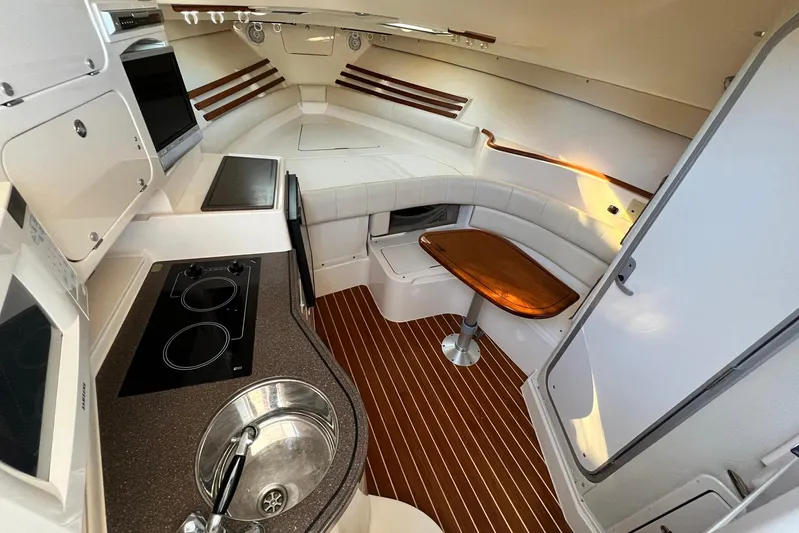 Zig Zag Yacht Photos Pics Interior of 2004 Grady-White Express 330 boat with kitchenette and seating area.
