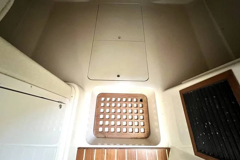 Zig Zag Yacht Photos Pics 2004 Grady-White Express 330 cabin interior with wooden floor and storage compartments.