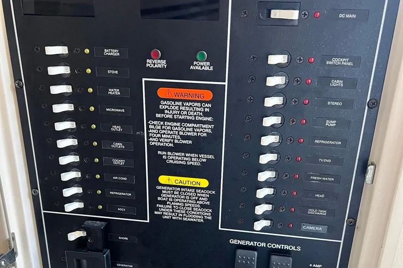 Zig Zag Yacht Photos Pics Electrical control panel on a 2004 Grady-White Express 330 boat with various switches and warnings.
