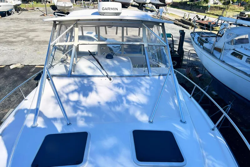 Zig Zag Yacht Photos Pics 2004 Grady-White Express 330 boat with Garmin equipment, docked in a marina.