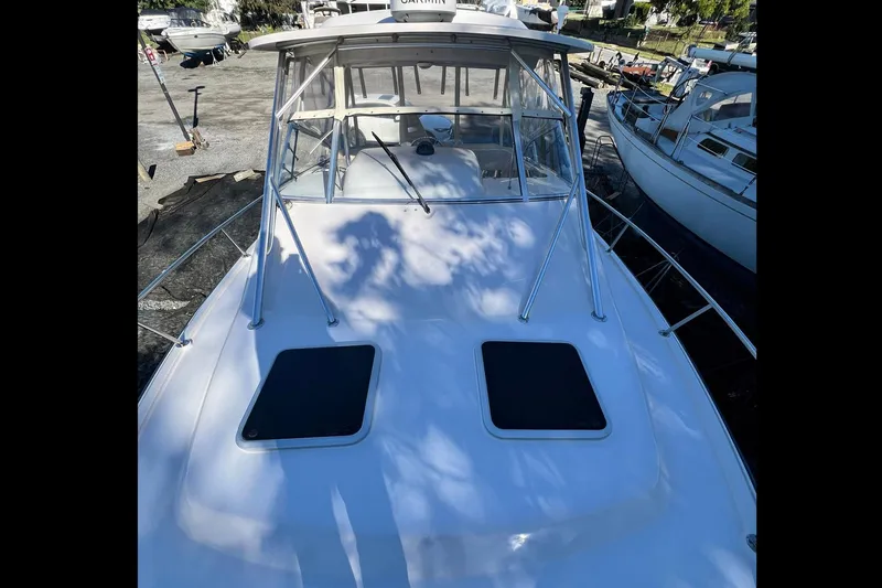 Zig Zag Yacht Photos Pics 2004 Grady-White Express 330 boat, docked with visible deck and cabin, surrounded by other boats.
